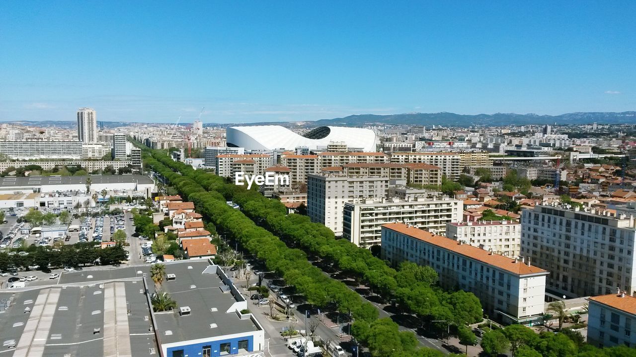 Buildings against clear sky on sunny day in city