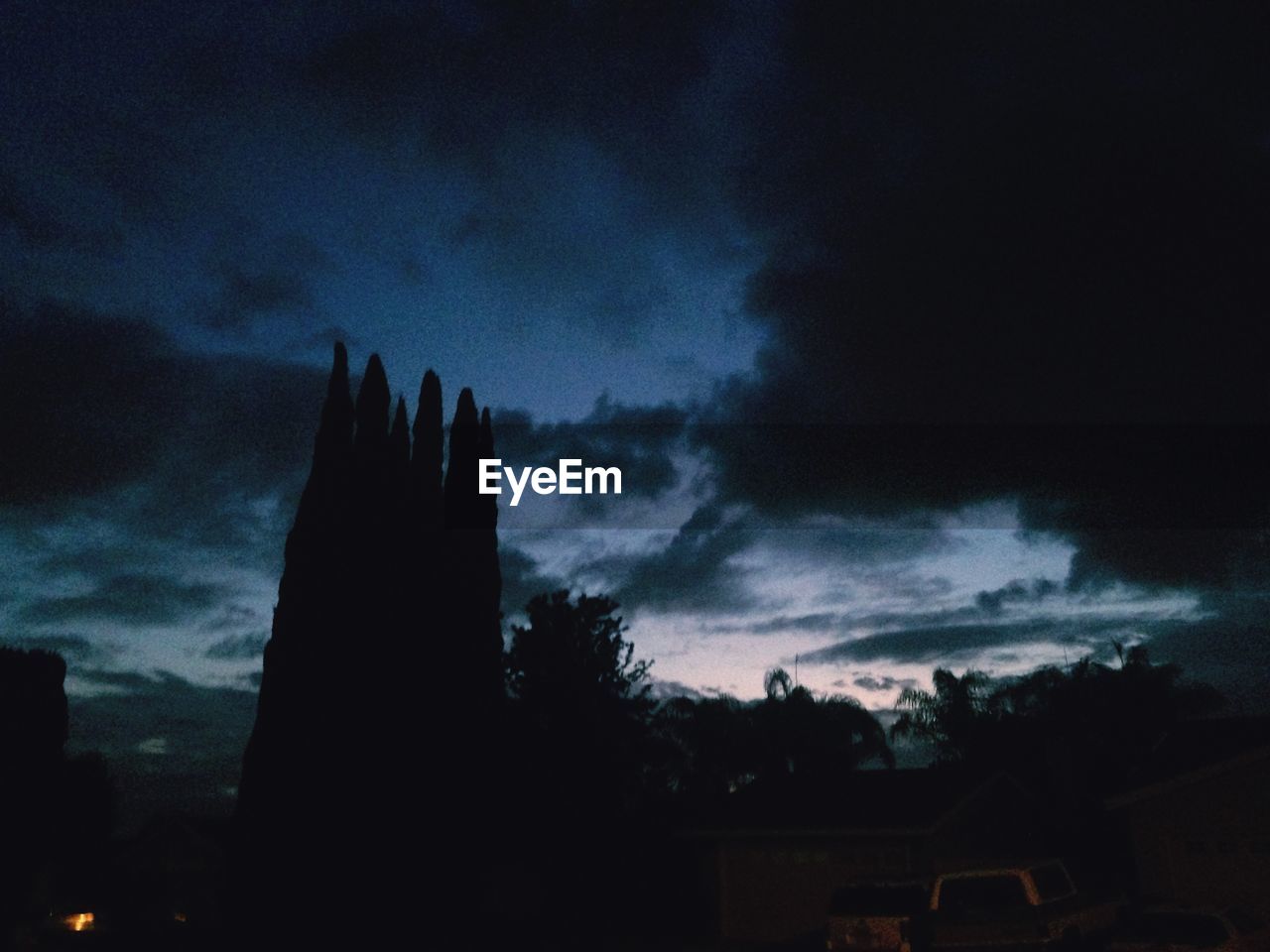 LOW ANGLE VIEW OF SILHOUETTE TREES AGAINST CLOUDY SKY