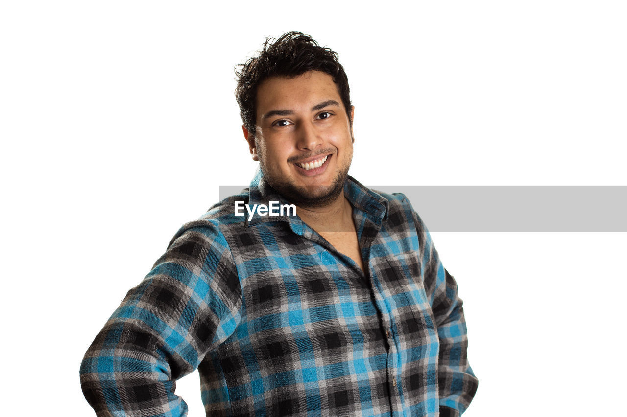 PORTRAIT OF A YOUNG MAN AGAINST WHITE BACKGROUND