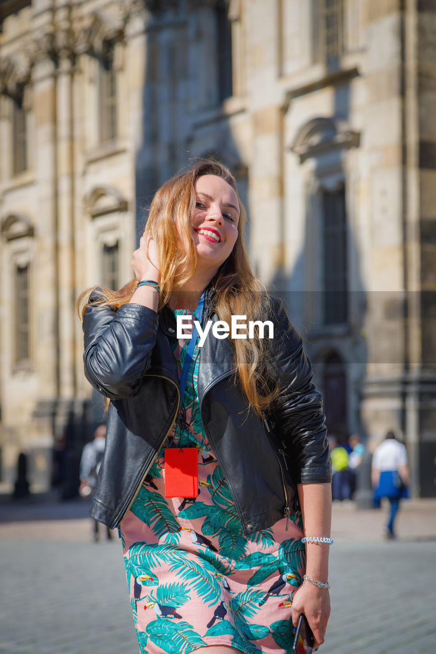 A young beautiful girl walks around the city on excursions.