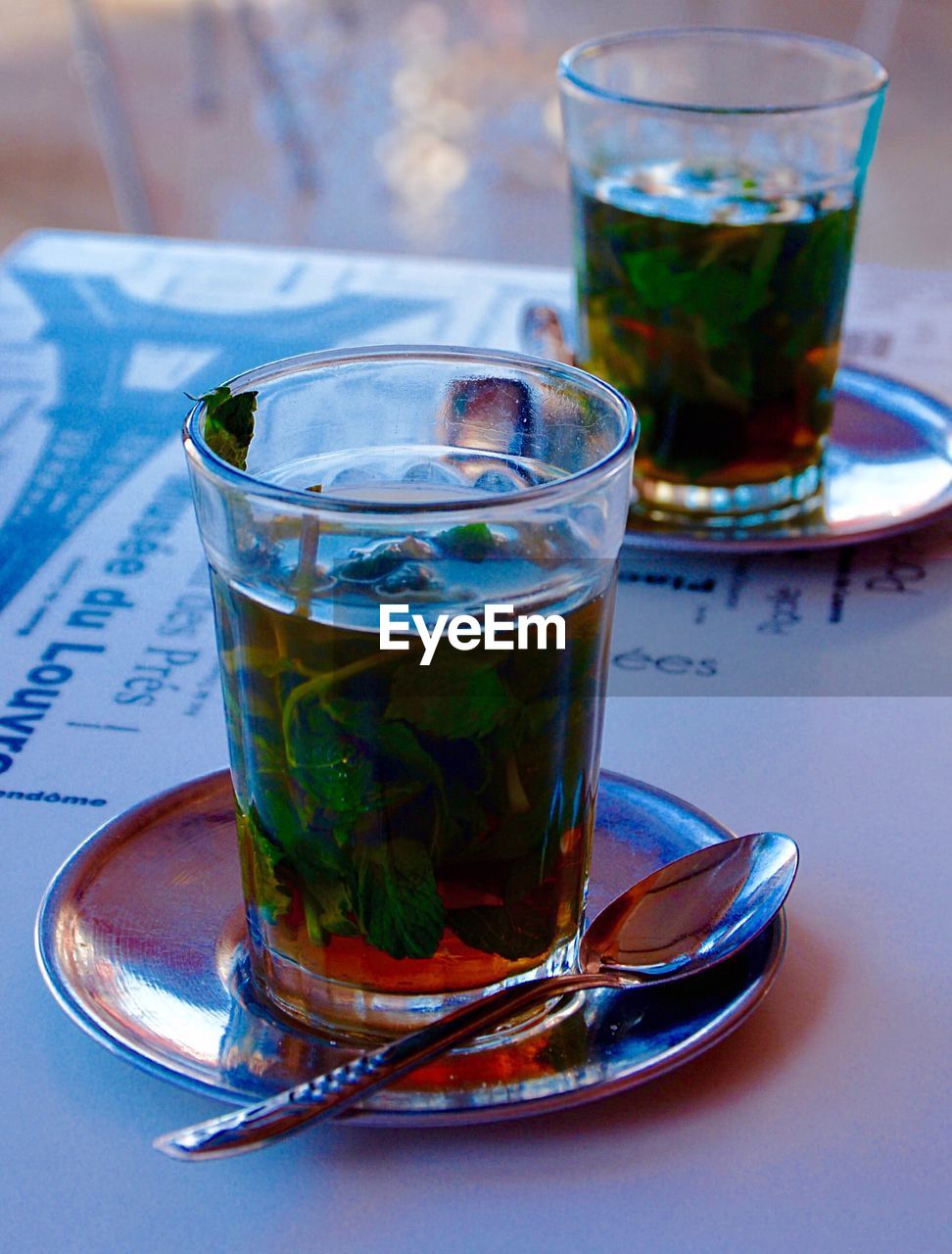 Mint tea served in glass on table