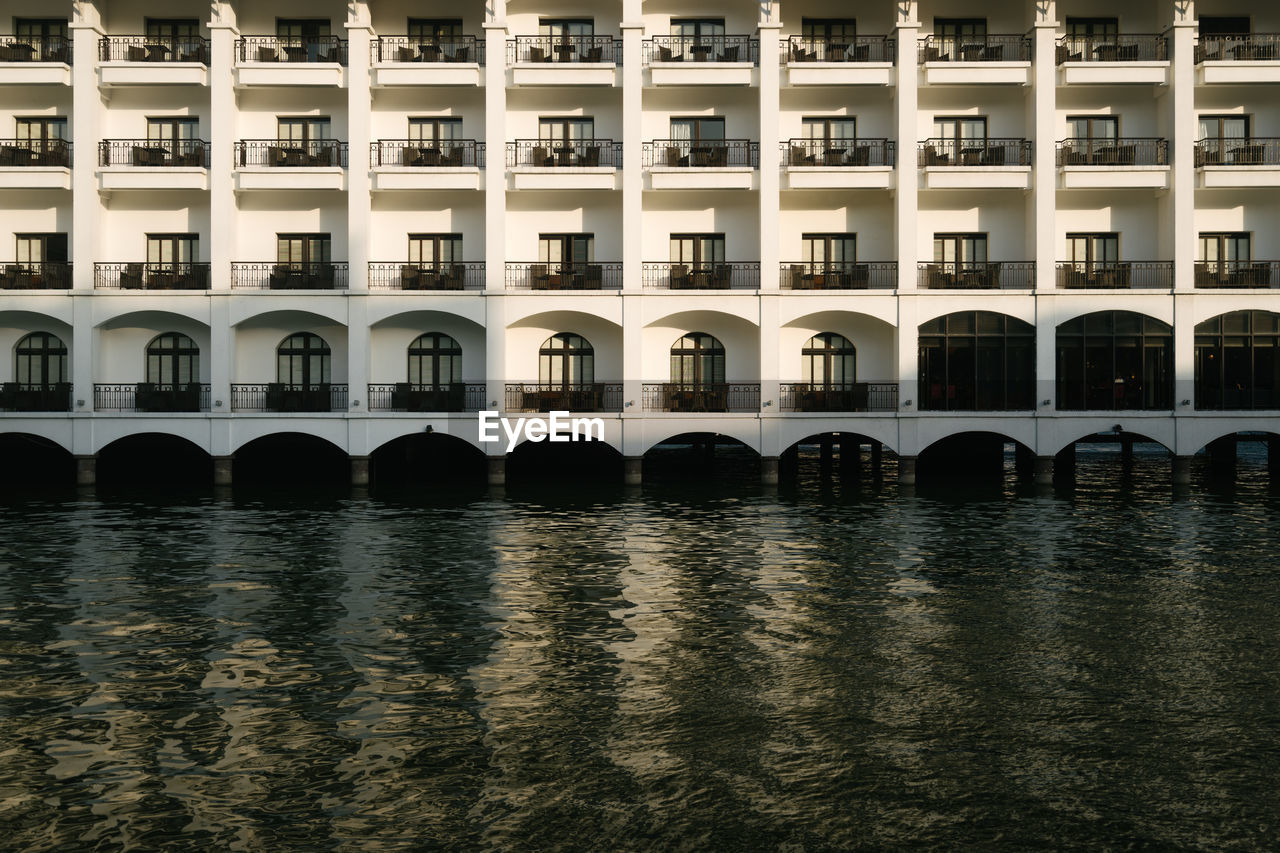 Buildings by river in city