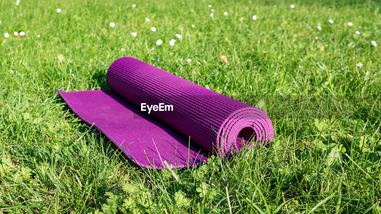Close up of rolled yoga mat on grass