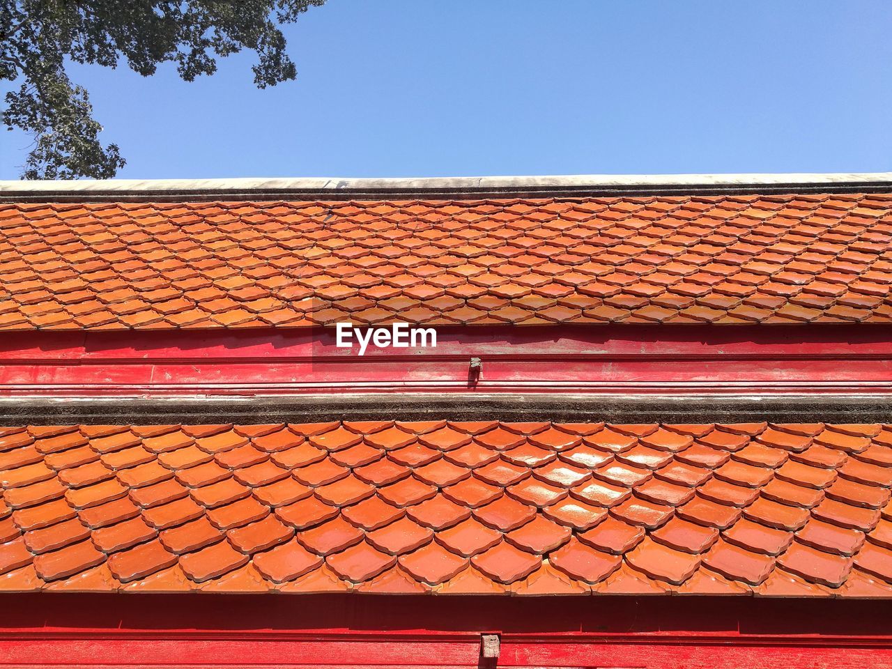 Low angle view of building roof against clear sky