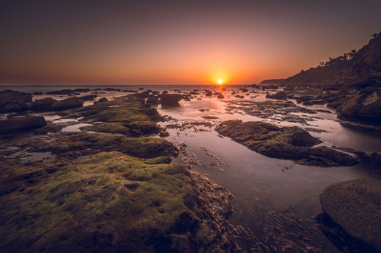 Scenic view of sea against sky at sunset