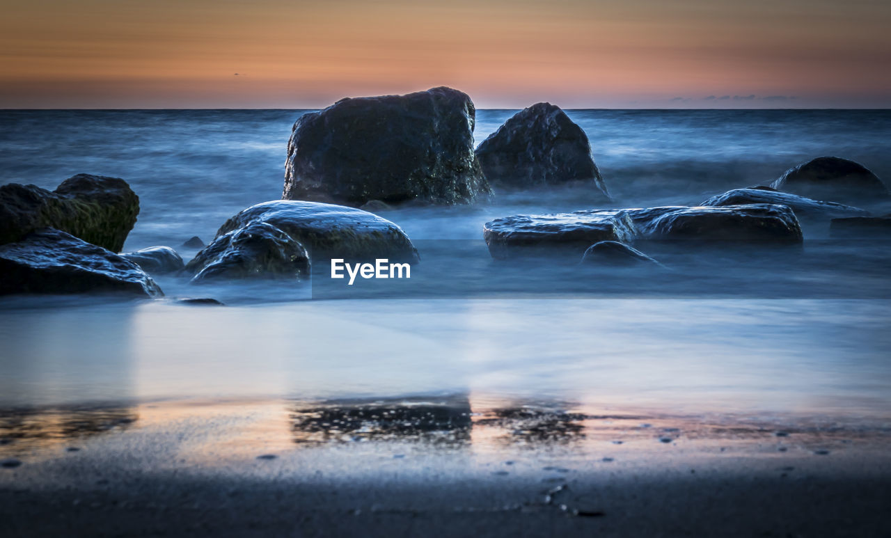 Scenic view of sea at sunset