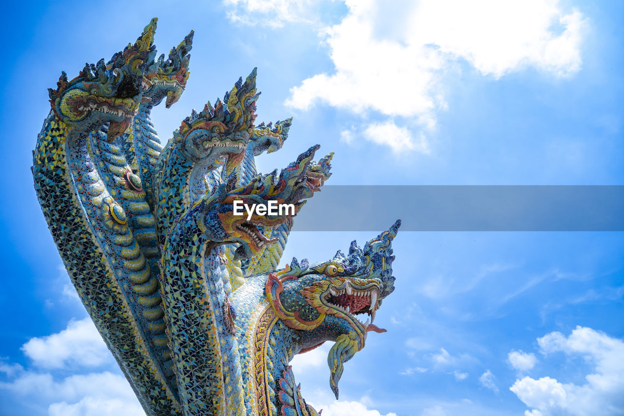 sky, cloud, religion, sculpture, architecture, nature, blue, belief, statue, temple - building, dragon, history, spirituality, tradition, travel destinations, no people, travel, the past, craft, culture, landmark, outdoors, low angle view, city, ancient, representation, built structure, building, animal, environment, day, symbol, ornate