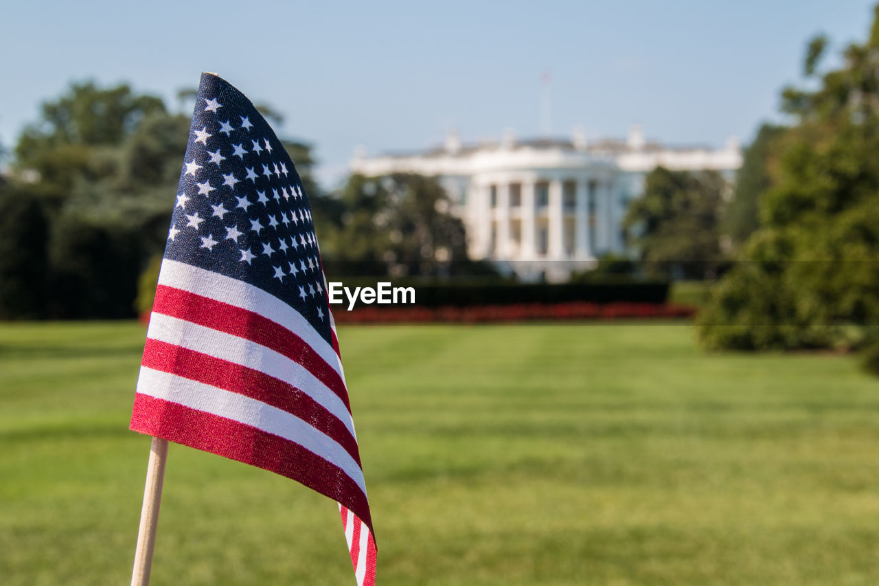 Close-up of american flag on grassy field