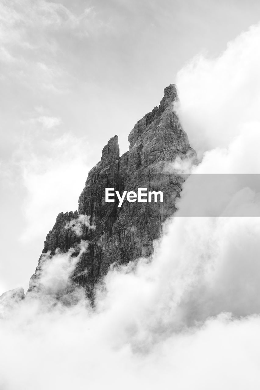 Low angle view of rock formation against sky