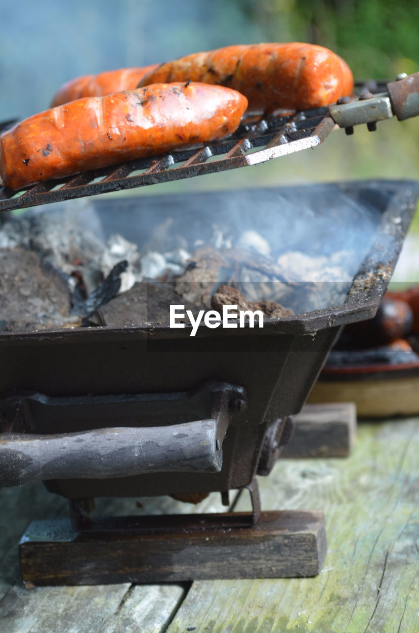Close-up of sausages being grilled on barbecue