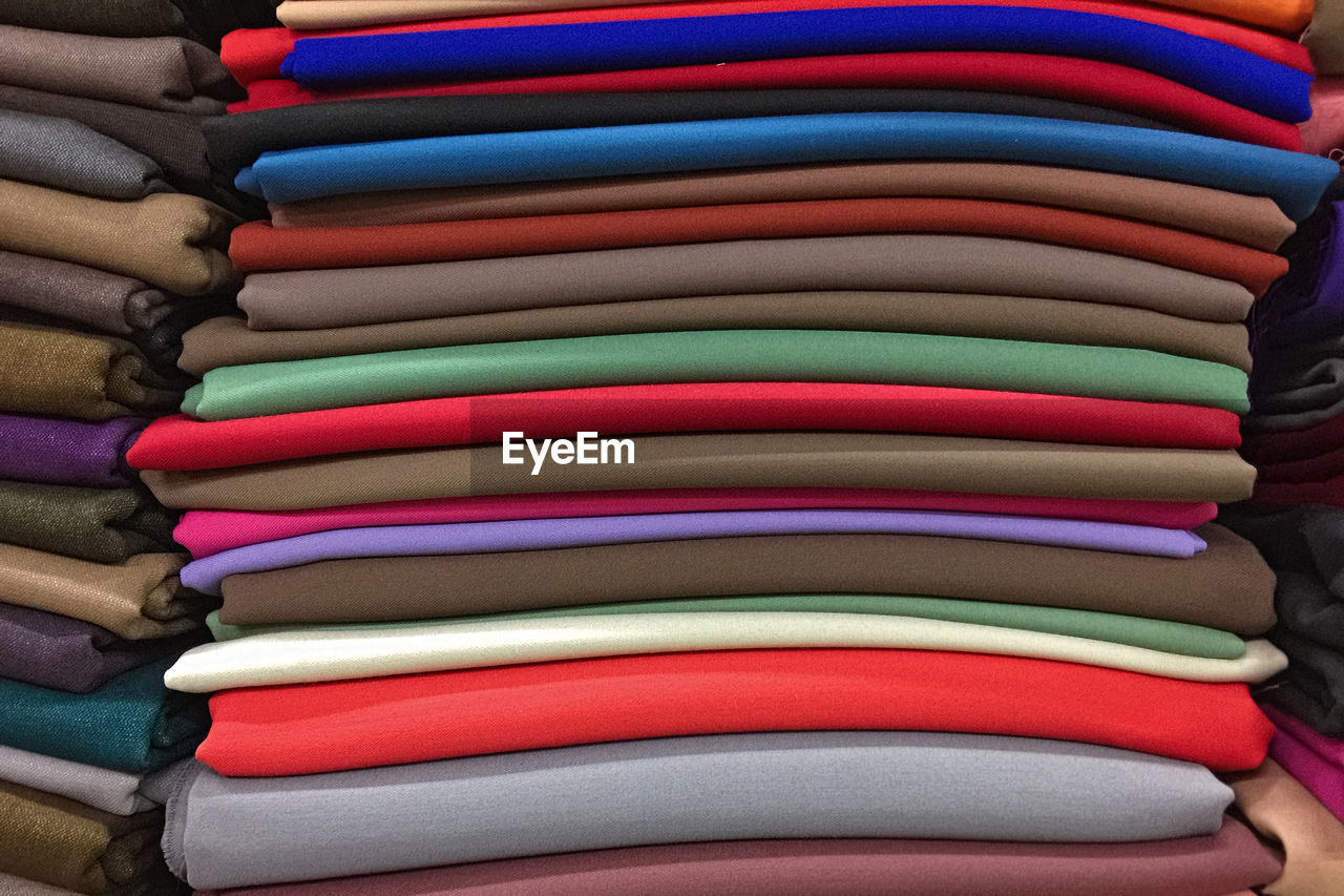 Stack of multicolored knitted fabric. textile industry, fabric sales.