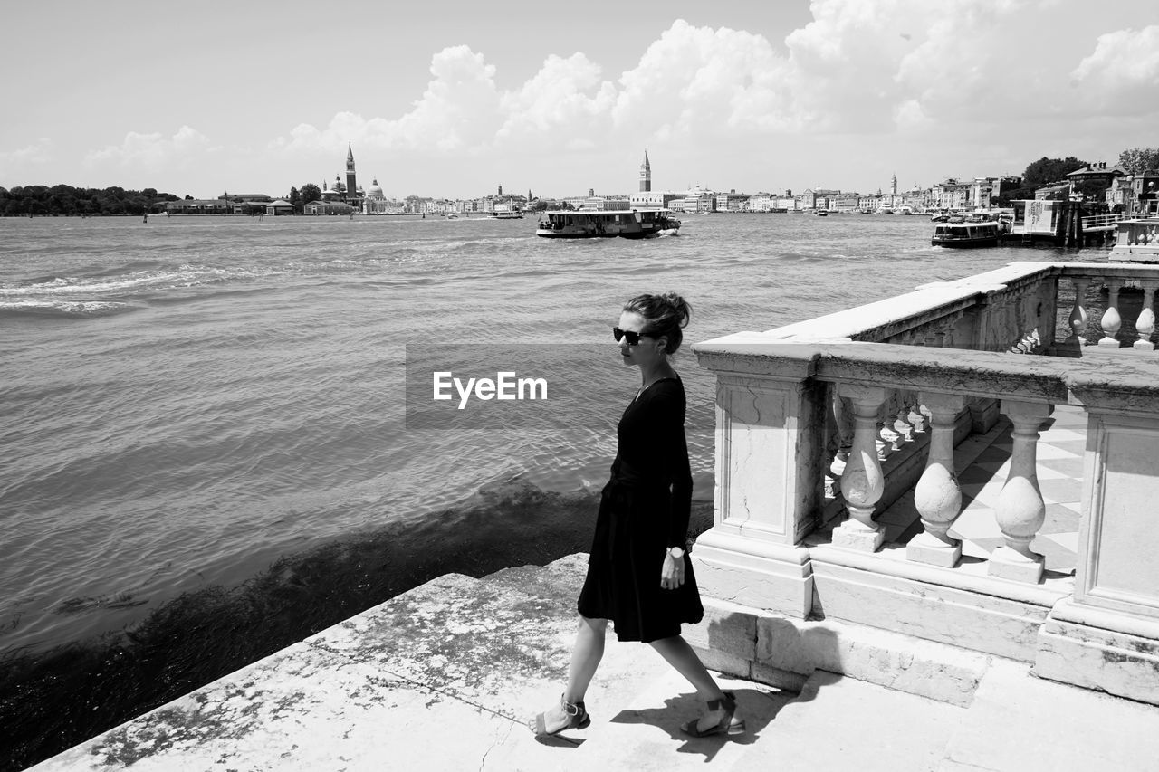 Woman walking at beach in city