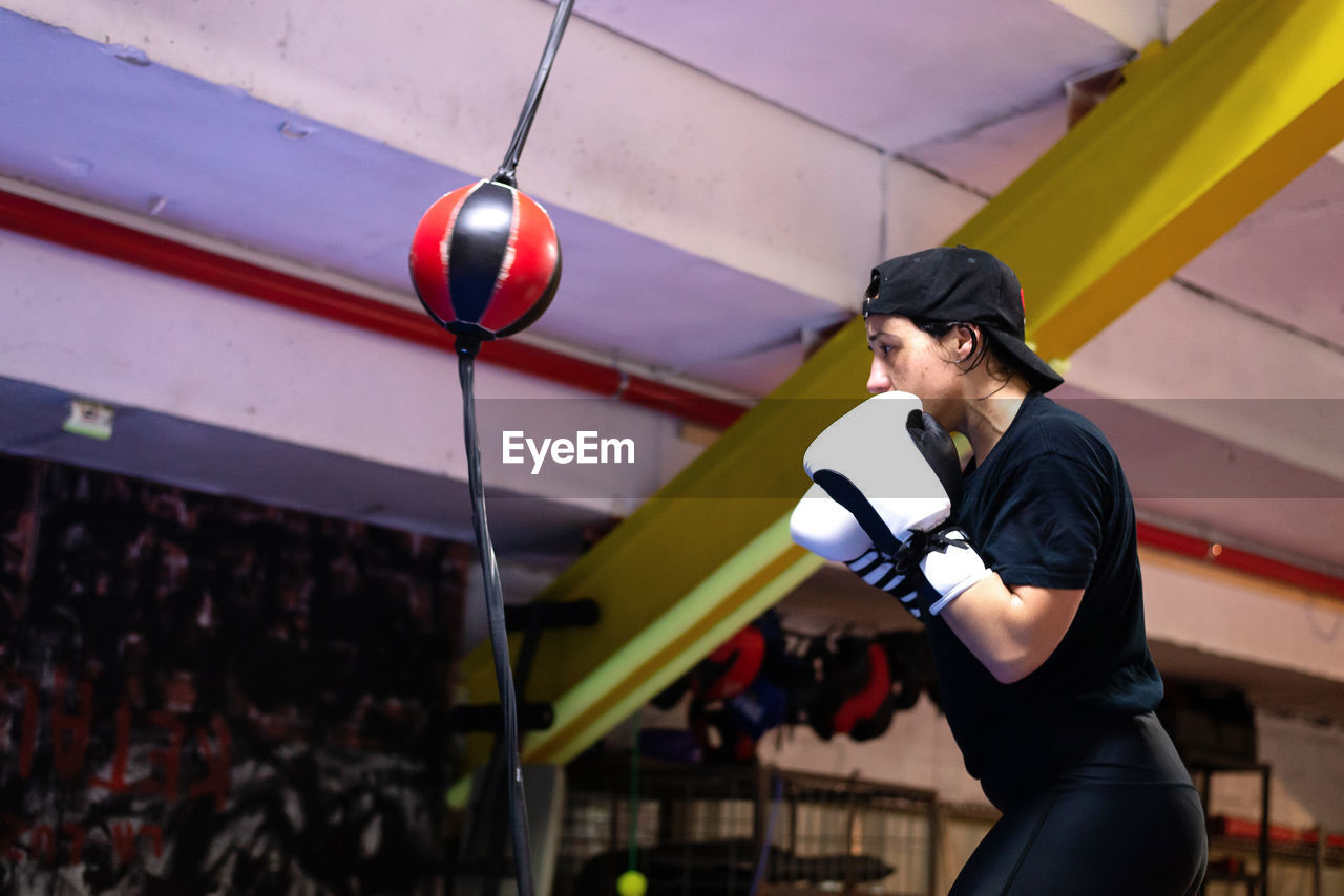 Boxer woman training at the punching ball