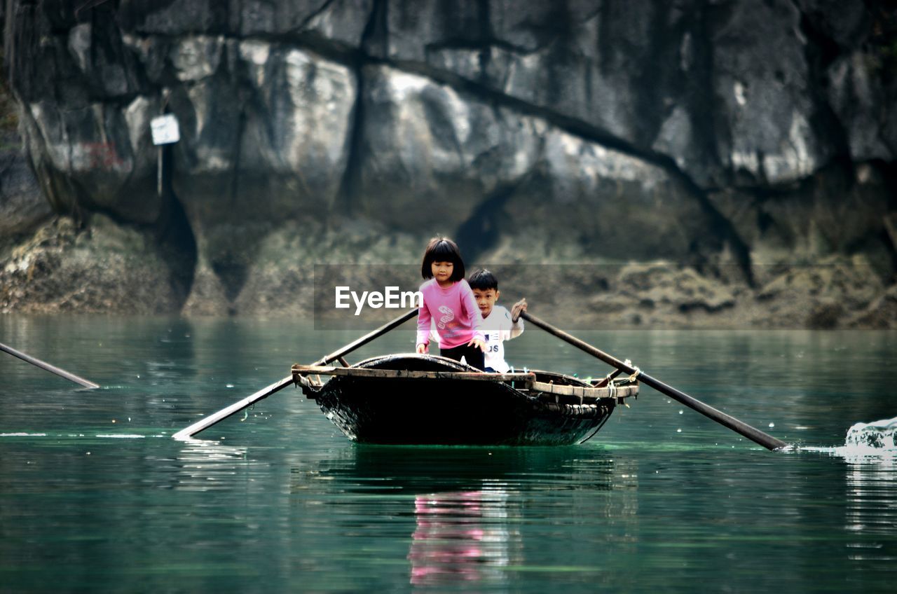 PEOPLE ON BOAT IN LAKE