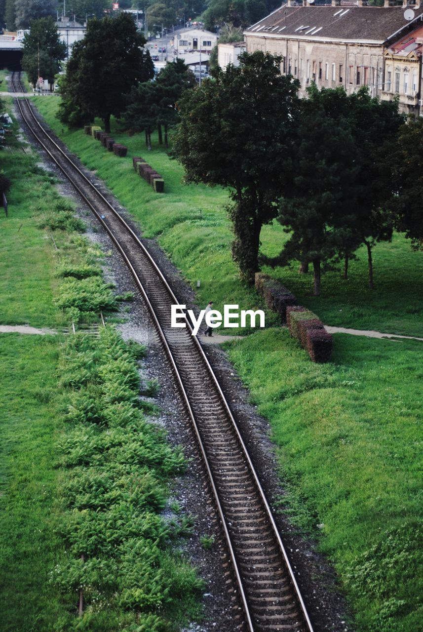 RAILWAY TRACKS AGAINST TREES AND SKY