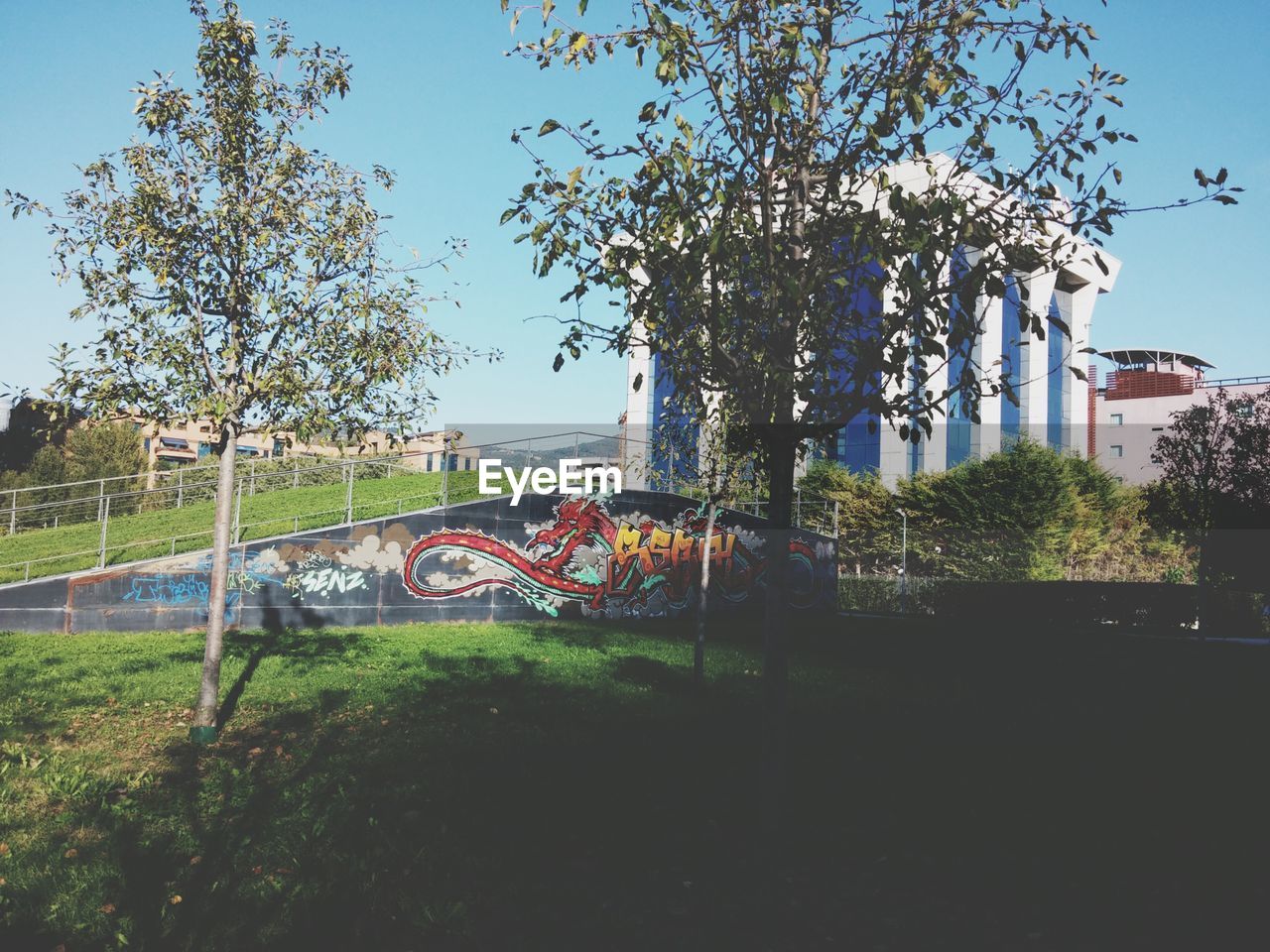 VIEW OF BUILT STRUCTURE WITH TREES IN FOREGROUND