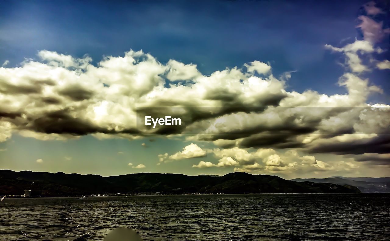 VIEW OF SEA AGAINST CLOUDY SKY