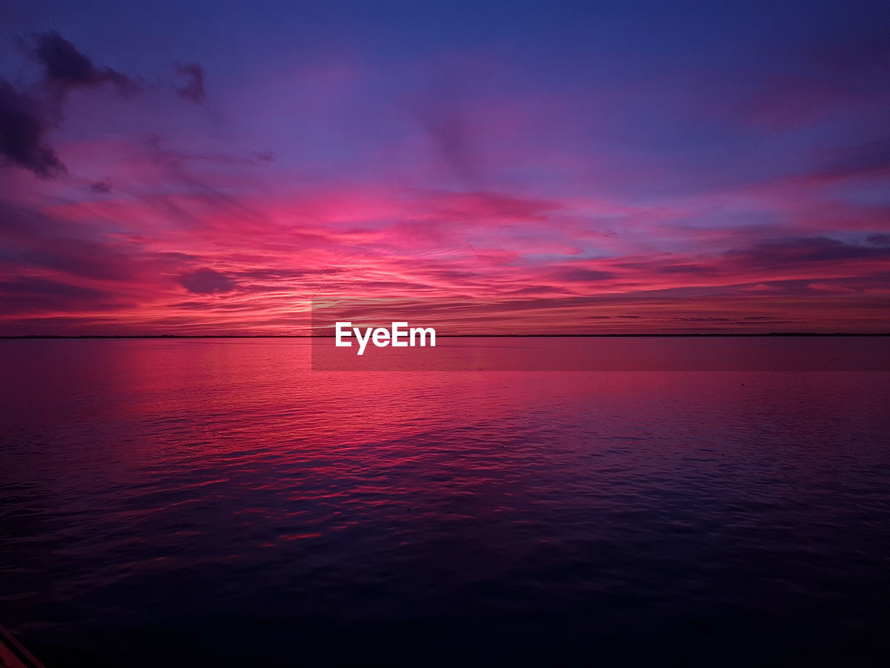 Scenic view of sea against romantic sky at sunset