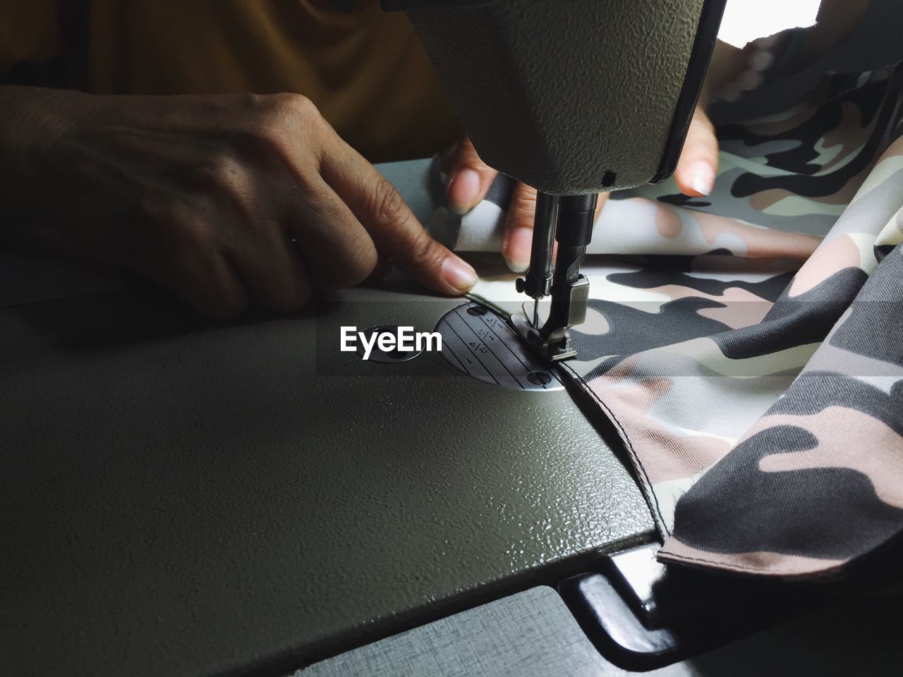 Close up of the tailor working on table