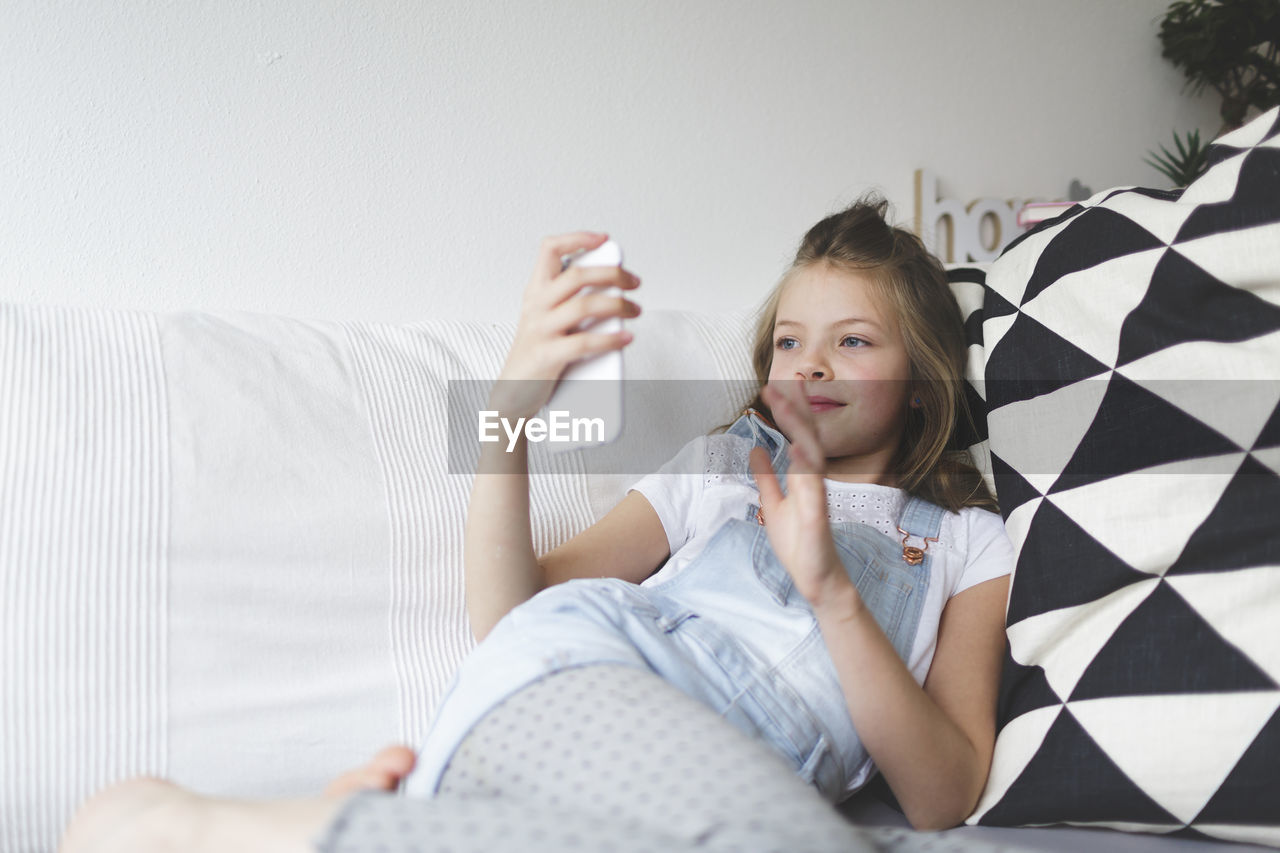 Girl waving hand during video call