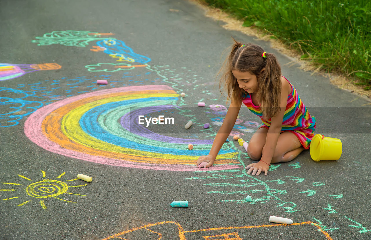 high angle view of girl playing with toy on road