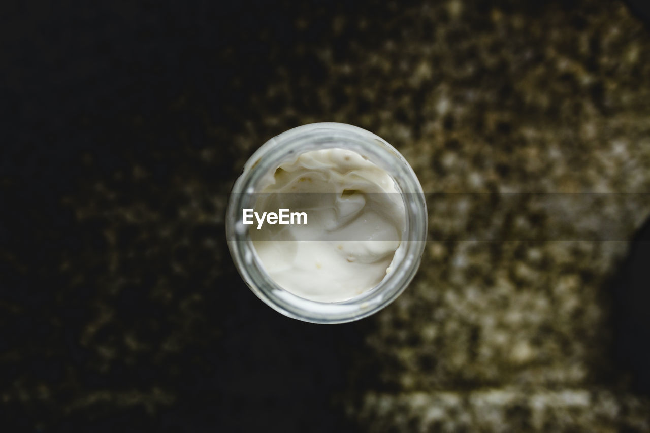High angle view of mayonnaise in jar on table