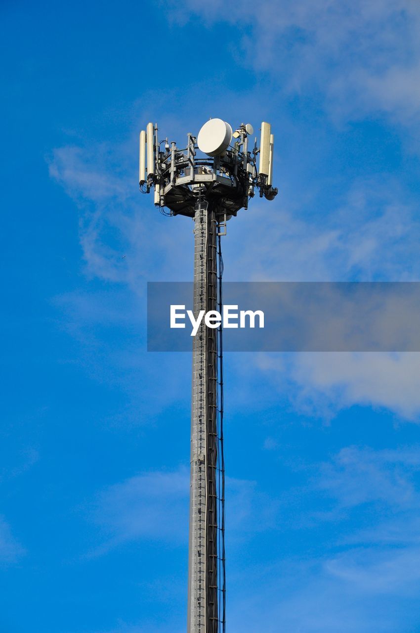 Low angle view of communications tower against sky