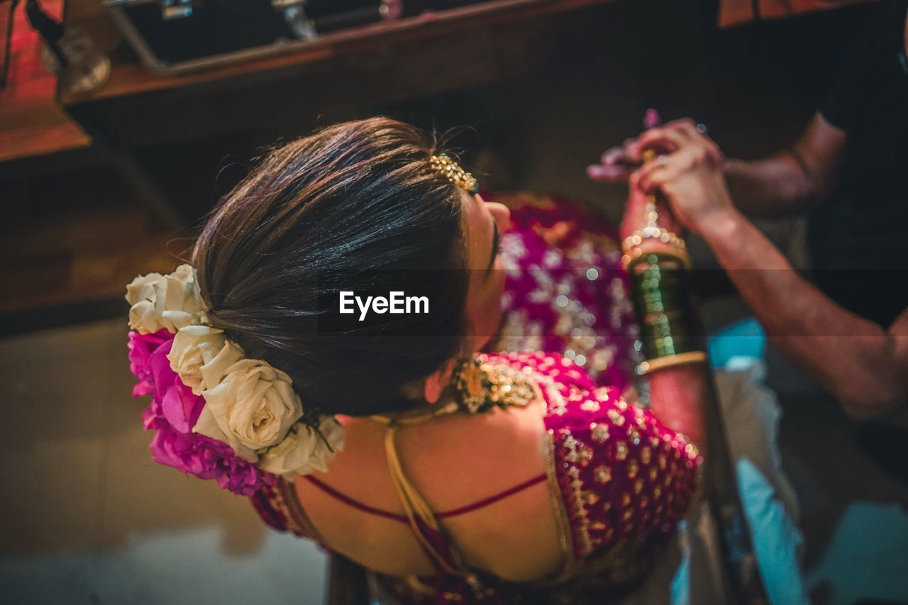 Rear view of woman wearing in sari sitting at home