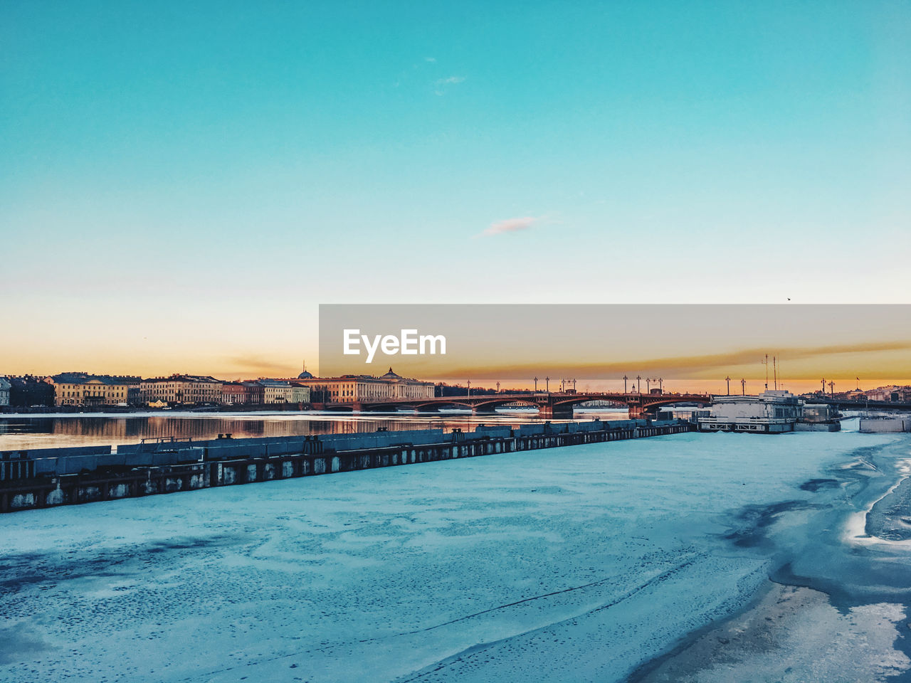 Bridge over river against sky during winter