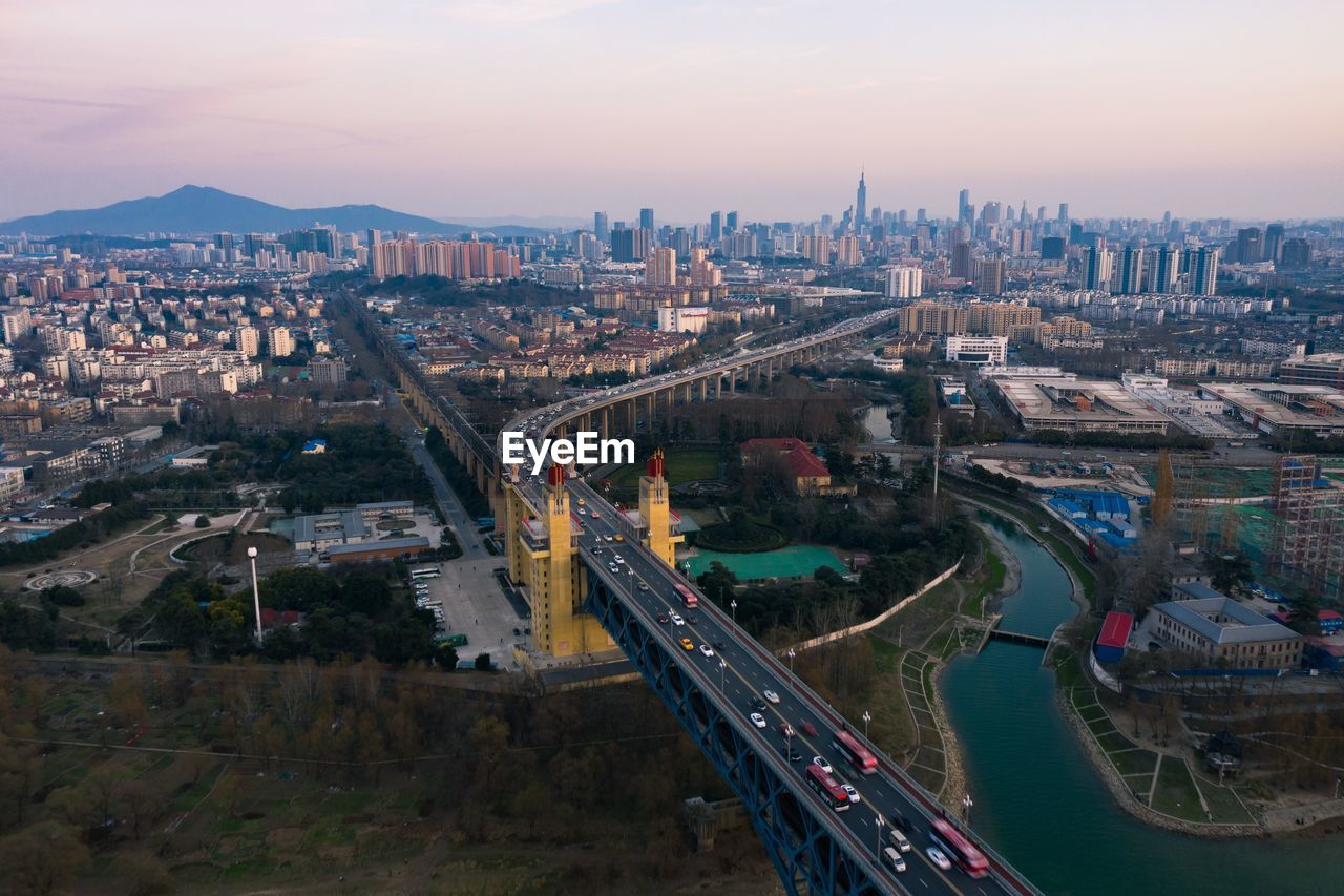 High angle view of road by buildings against sky