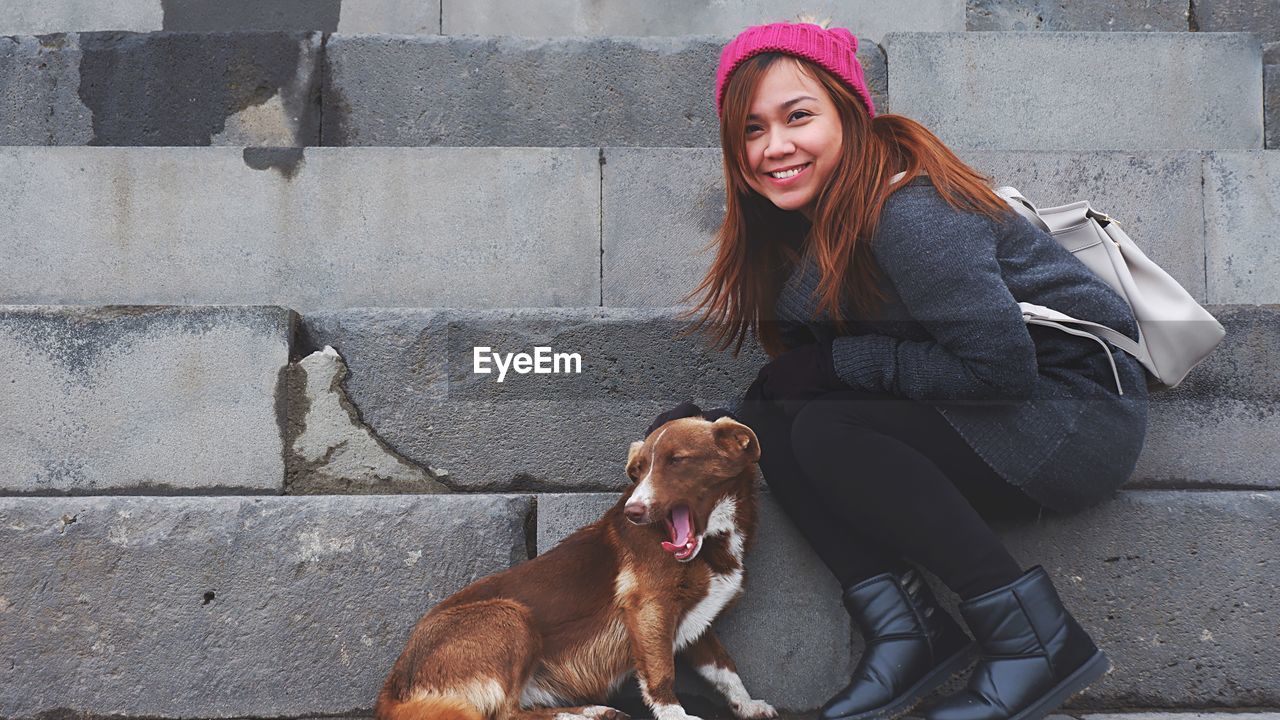 Smiling young woman with dog
