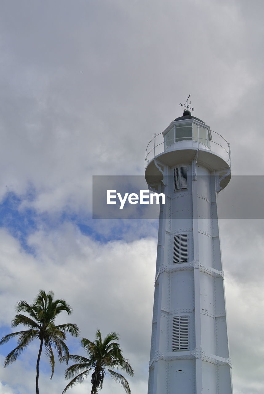 Low angle view of lighthouse against cloudy sky