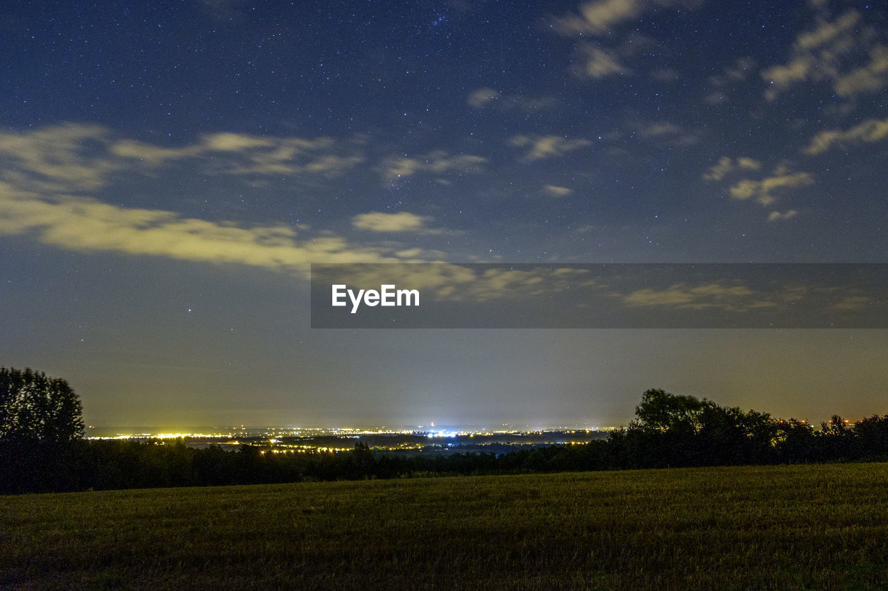 FIELD AGAINST SKY AT NIGHT