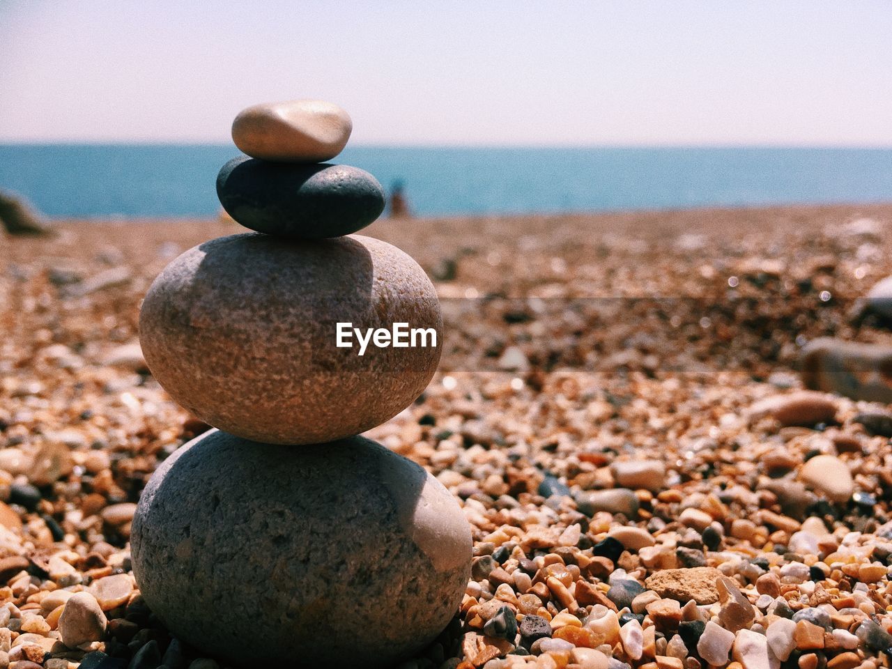 Stack of pebbles at beach during summer