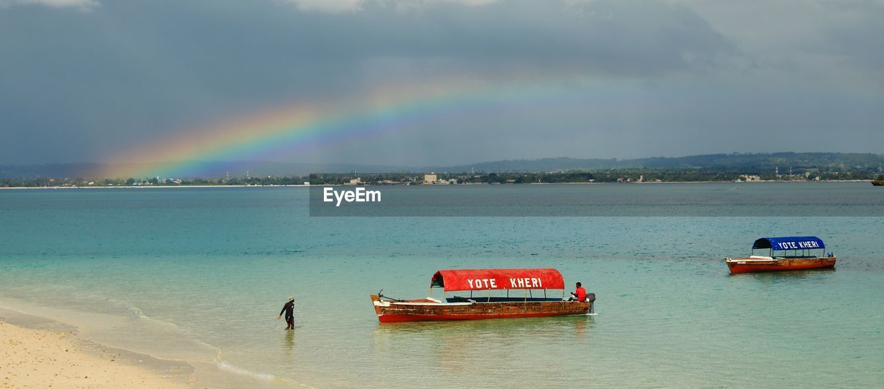 RAINBOW OVER SEA AGAINST SKY