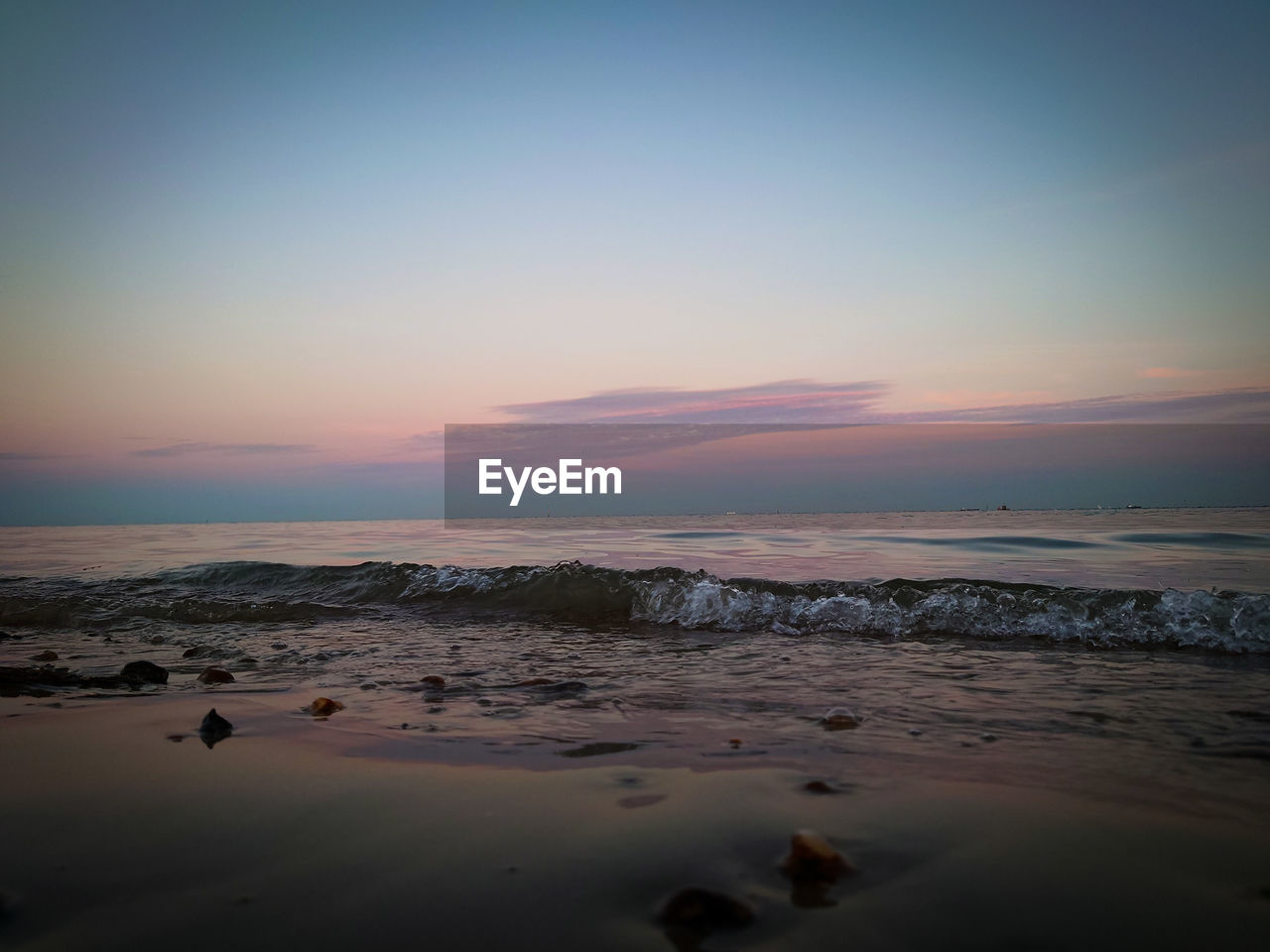 Scenic view of beach against sky during sunset