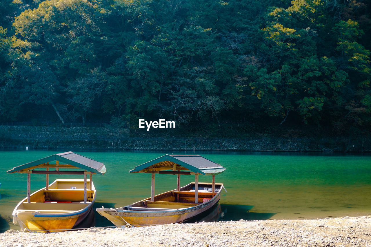 BOAT MOORED ON LAKE SHORE