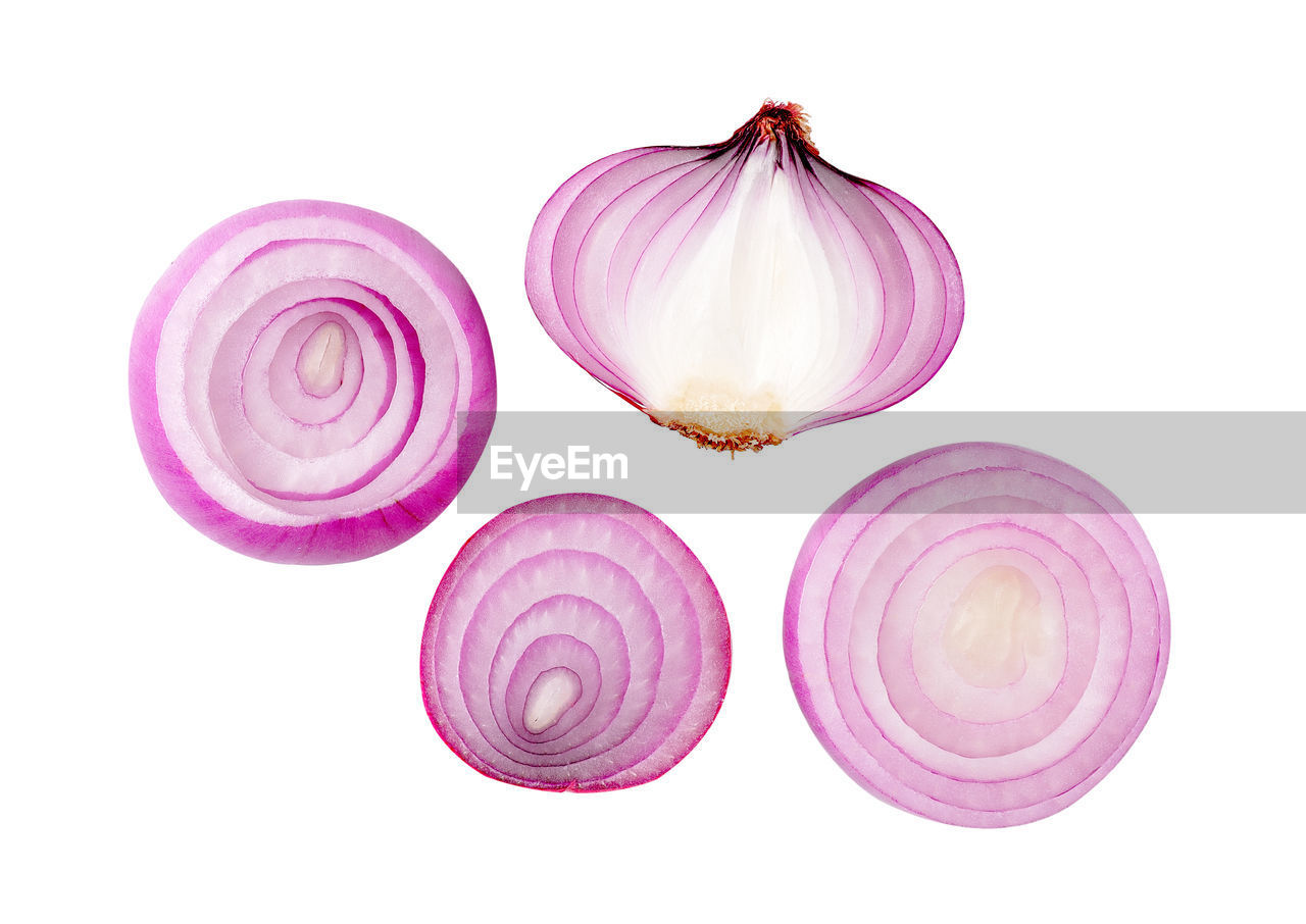 DIRECTLY ABOVE SHOT OF PINK SLICES AGAINST WHITE BACKGROUND