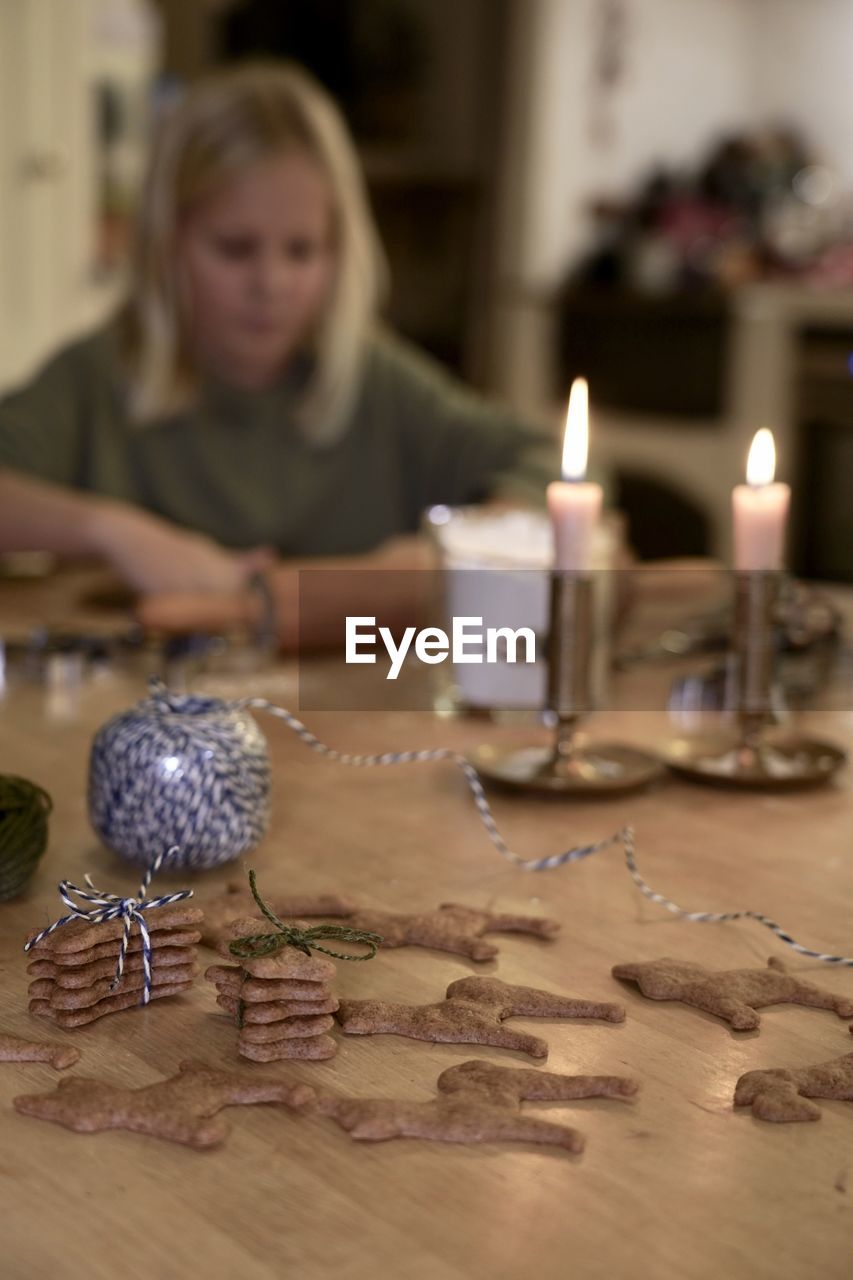 Portrait of girl baking gingerbread cookies on table