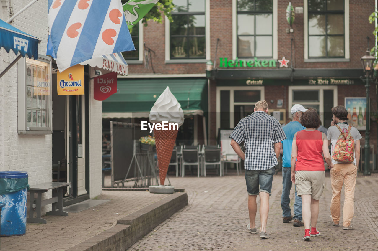 WOMAN STANDING ON CITY STREET