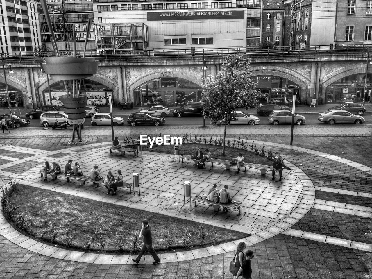 High angle view of people in park in front of buildings