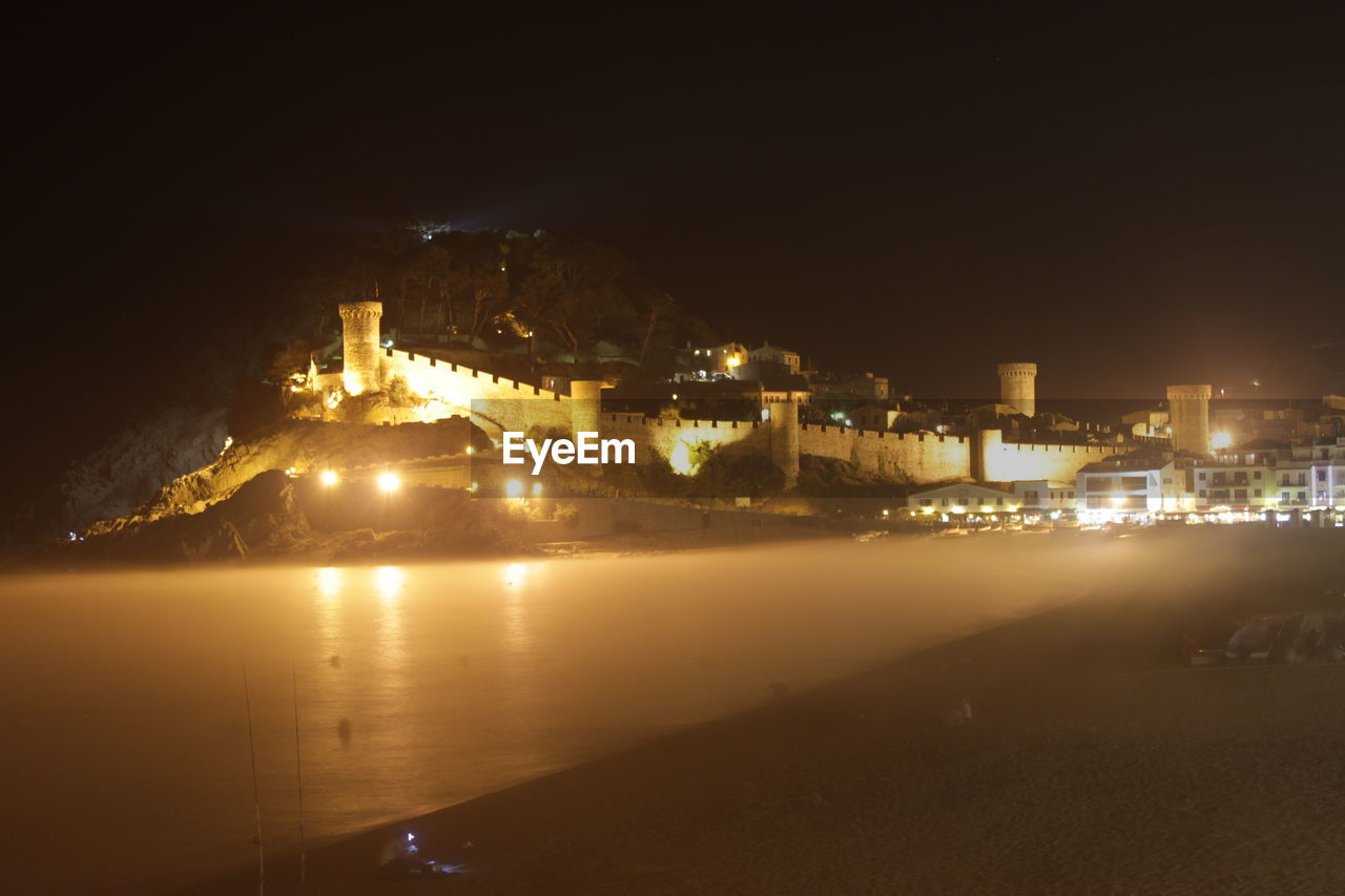 VIEW OF ILLUMINATED BUILDINGS AT NIGHT