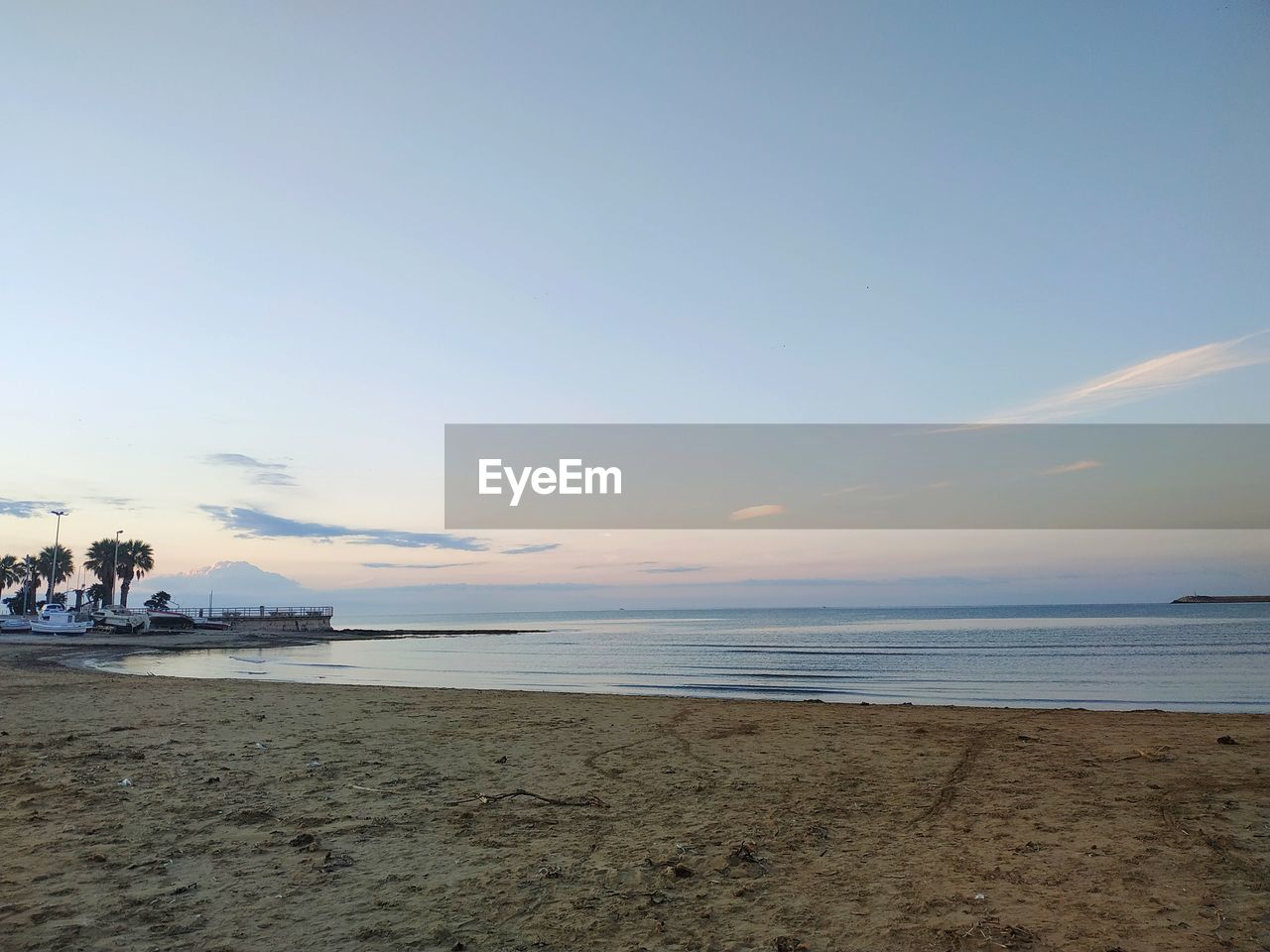 SCENIC VIEW OF BEACH DURING SUNSET