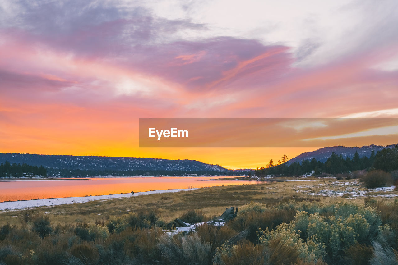 Scenic view of lake against sky during sunset