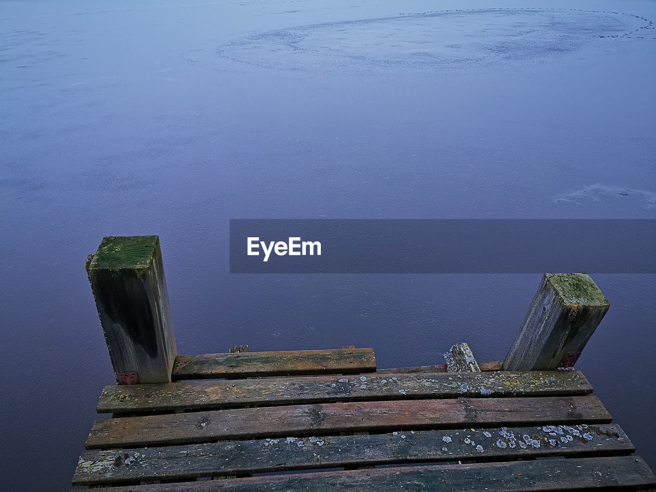 HIGH ANGLE VIEW OF ABANDONED PIER ON LAKE