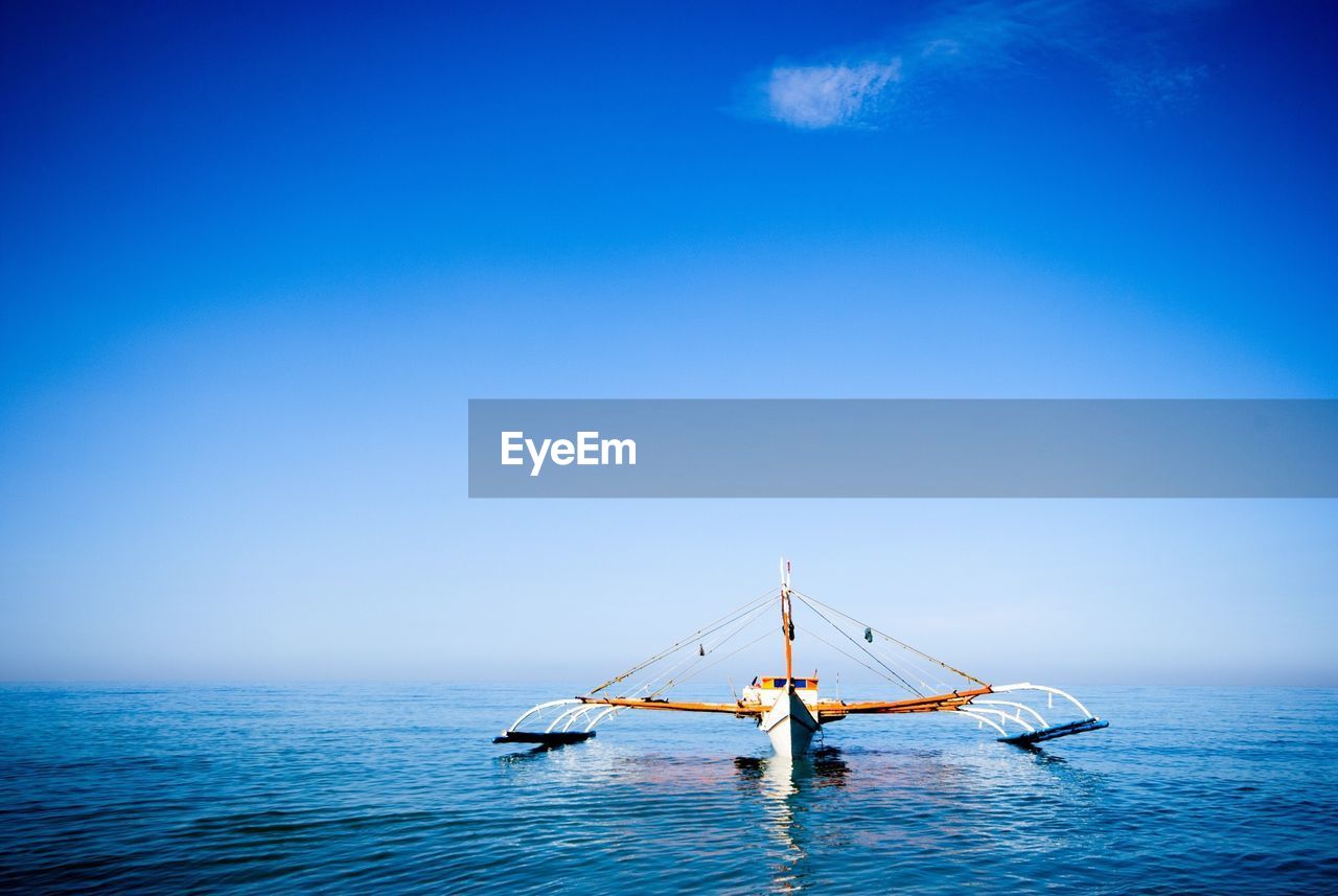 Boat sailing in sea against sky