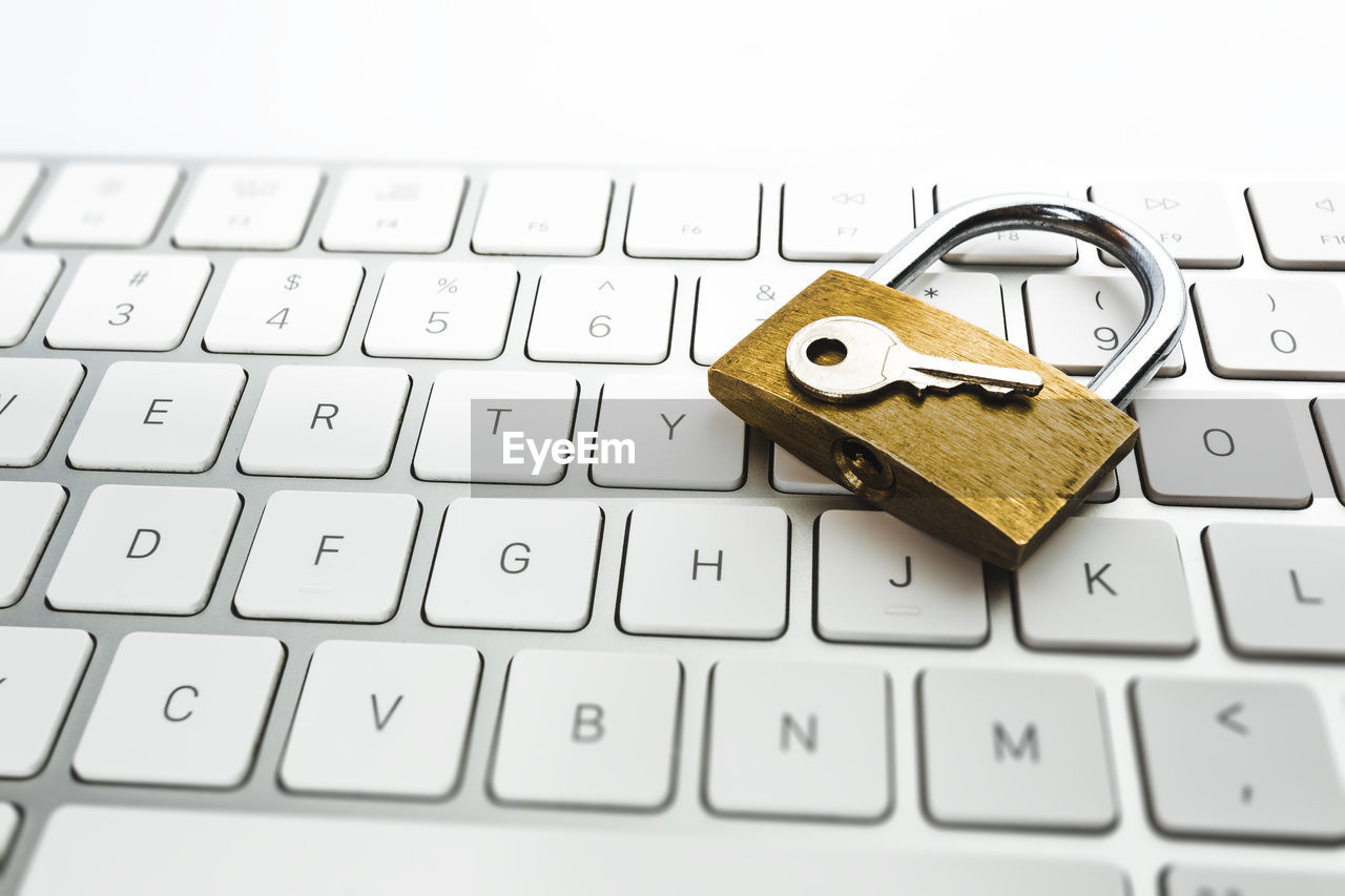 Close-up of padlock and key on keyboard