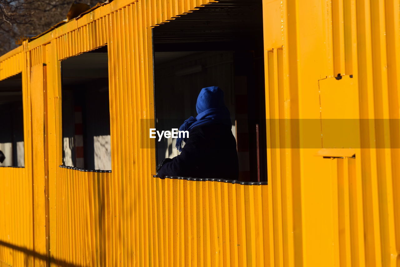 low section of woman standing by closed door