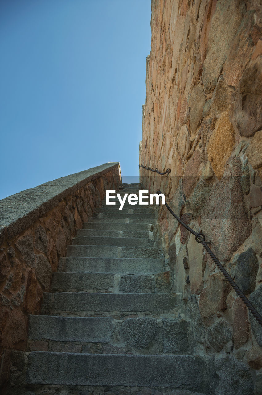 LOW ANGLE VIEW OF STEPS AGAINST BLUE SKY