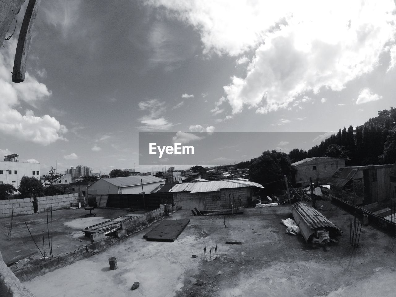 HIGH ANGLE VIEW OF HOUSES AGAINST CLOUDY SKY